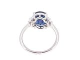 an image of a ring with a blue sapphire and diamonds