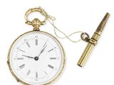 an old pocket watch with a pen on a white background