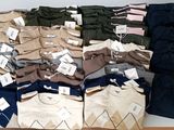 many pairs of men ' s clothing on display in a store