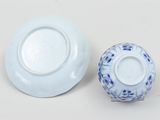 a white plate and a blue and white bowl on a table