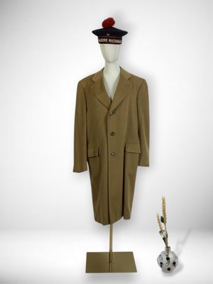 coat and hat on a mannequin stand in a white room