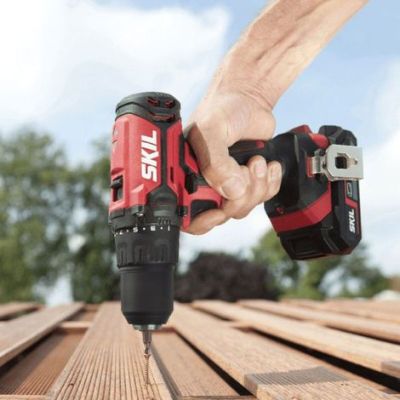 a person using a cordless drill to drill a piece of wood