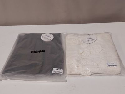 two bags of clothing sitting on a table next to each other