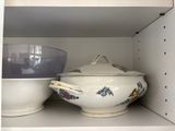 two bowls and a bowl on a shelf in a cabinet
