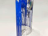 a sculpture made out of blue sticks on a white surface