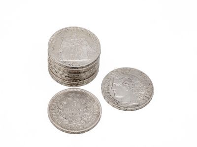 three coins are stacked on top of each other on a white surface
