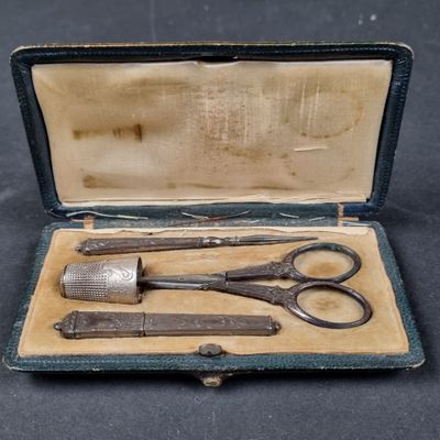 two pairs of scissors in a case on a table