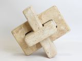 cement sculpture of a cross on a white background