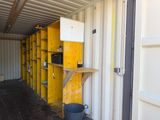 a storage room with yellow shelvings and a black bucket