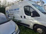 a white van that is parked next to a white car