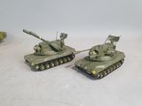 two toy tanks sitting next to each other on a table