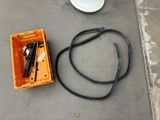an orange box with tools on the floor next to a white toilet