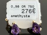 a pair of amethyste earrings with a price tag