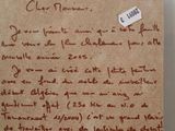 a piece of paper with writing on it in a glass case