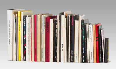 many books that are stacked on top of each other