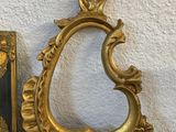 a gold picture frame and a book on a table