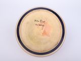 a small bowl with writing on it sitting on a table