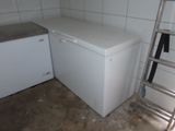 an image of a kitchen with a white refrigerator and a ladder