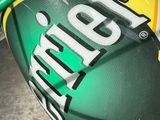 a close up of a can of beer wrapped in a green wire