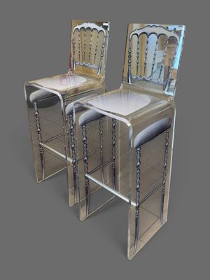 pair of mirrored bar stools in the shape of a pair of chairs