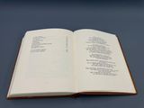 an open book sitting on top of a table next to a blue table