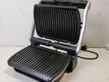 a close up of a black and silver grill on a counter