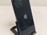 a black iphone sitting on a stand on a white surface
