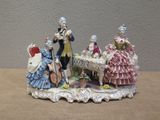 a figurine of a group of people sitting at a table
