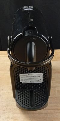 a close up of a coffee maker on a wooden table