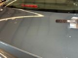 a close up of a car ' s tail light on the hood