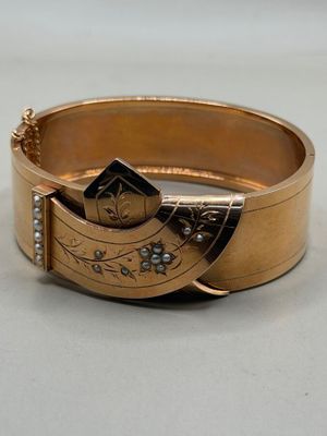 an image of a close up of a gold bracelet on a table