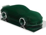 a green car made out of paper on a plate