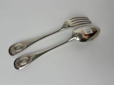 two silver spoons and a fork on a white surface