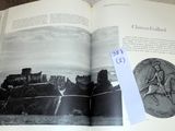 an open book with a picture of a castle on it