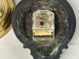 two clocks on the wall next to each other