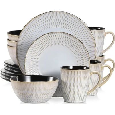 a stack of cups and saucers sitting on a white table