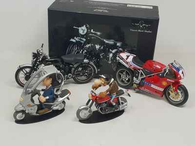 four figurines of motorcycles in front of a black box