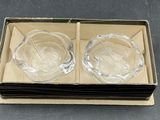 two clear glass bowls in a cardboard box on a table
