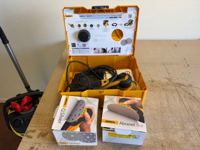two boxes of tools sitting on a table next to each other