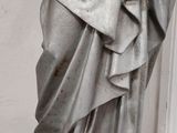 a statue of jesus holding a cross in his hands