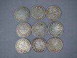 six different types of silver coins on a blue surface