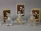 five small bottles of perfume sitting on a table