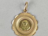 a gold coin with a woman in the center of it