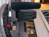 someone is using a circular saw to cut a piece of wood with a circular saw