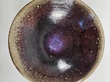 a small bowl with a purple and blue design on it