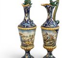 pair of blue and white vases with a painting of a man and woman on them