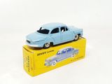 a blue toy car sitting on top of a yellow box