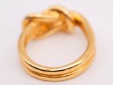 a close up of a gold ring on a white surface