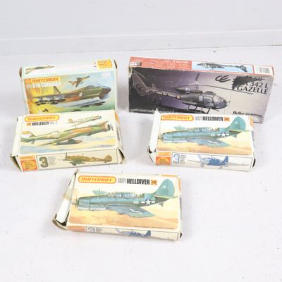 several boxes of assorted model airplanes sitting on a white surface