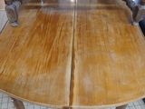 a wooden table with two chairs on top of it